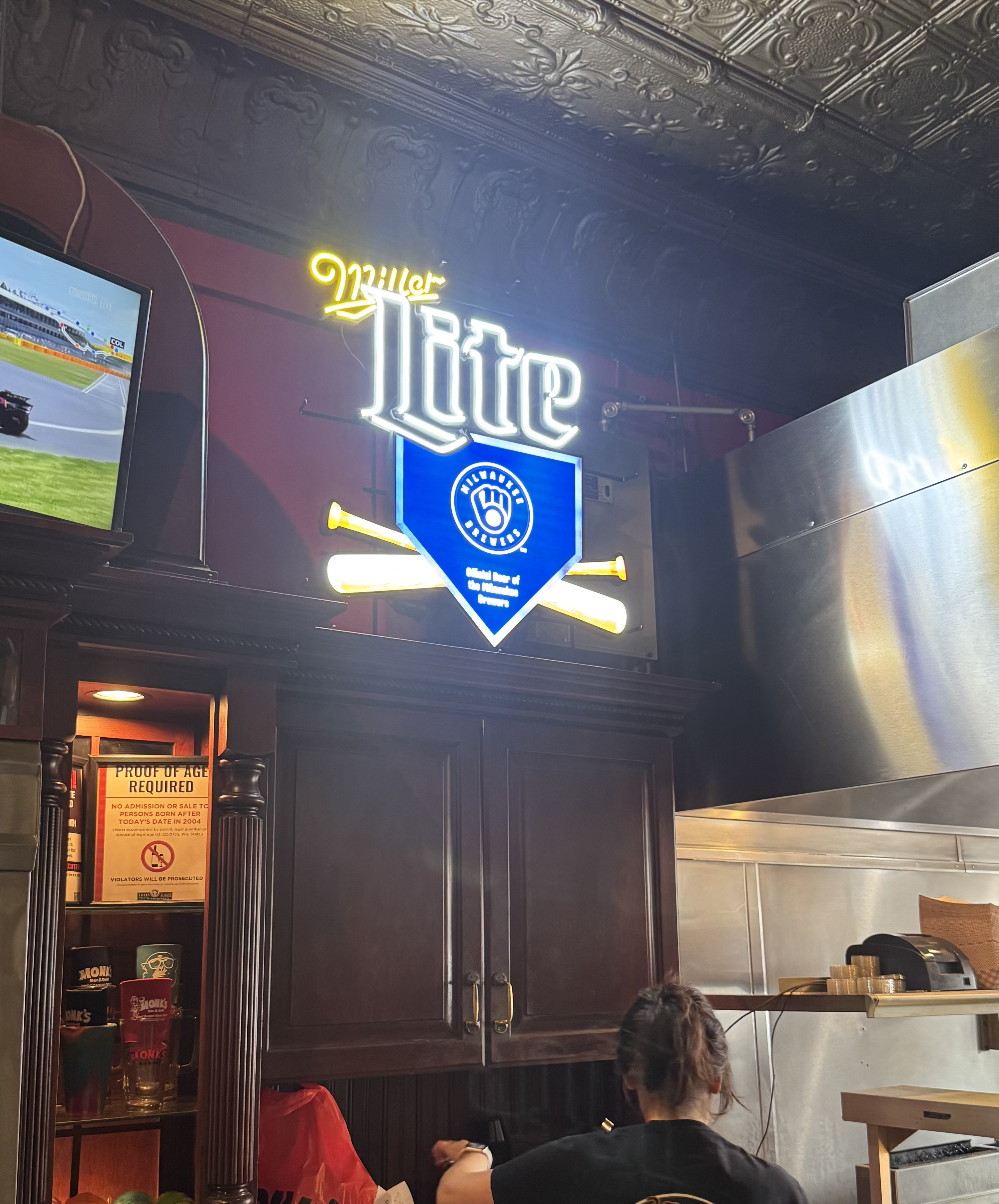 Conceptual Rendering (left) Actual production sign hanging in restaurant